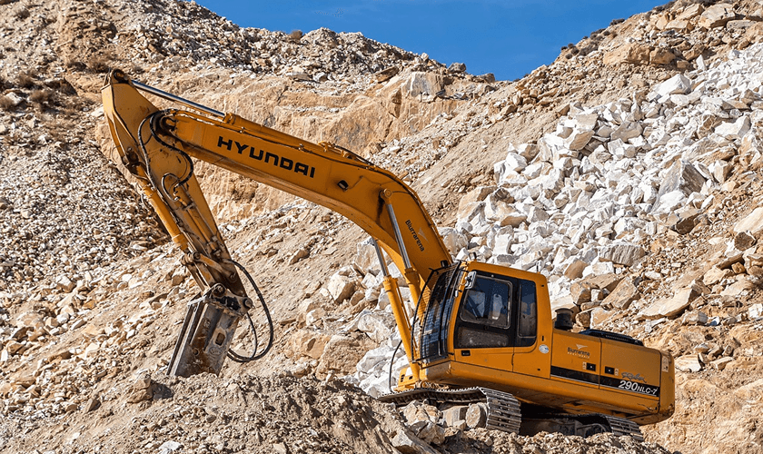 Quarrying operations with an excavator in a quarry